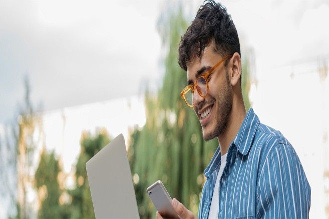 male-looking-phone-smiling