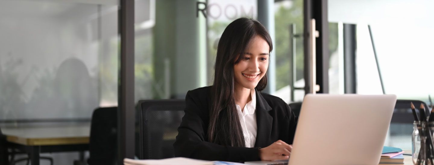Woman happy working on laptop